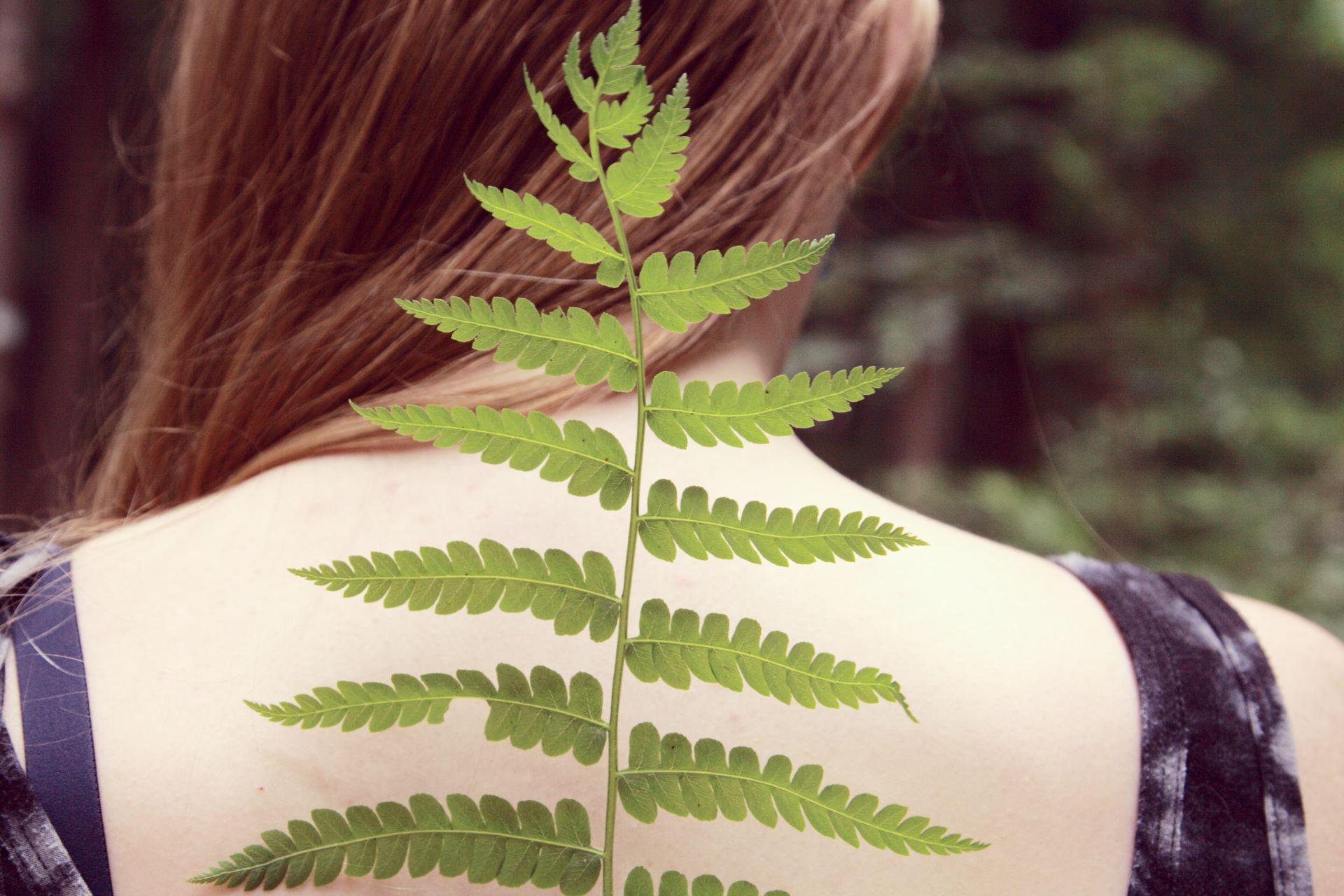 woman in black and white tank top with green leaf on her back