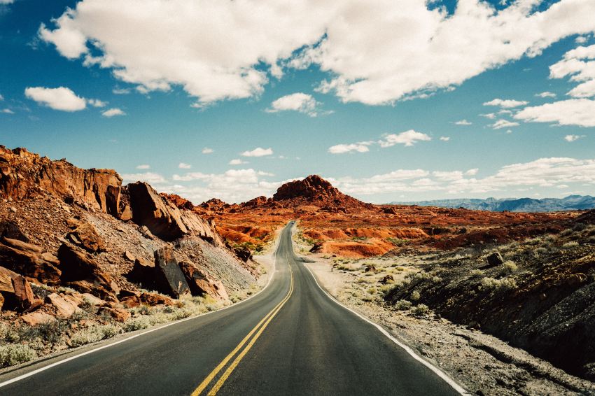 road under white and blue sky