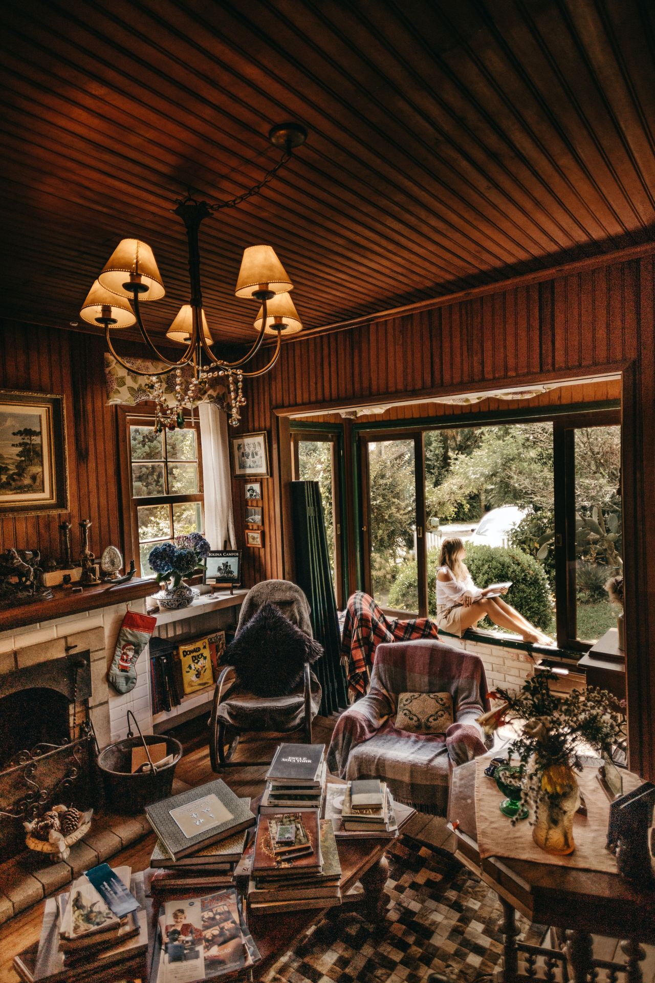 woman sitting on window inside room