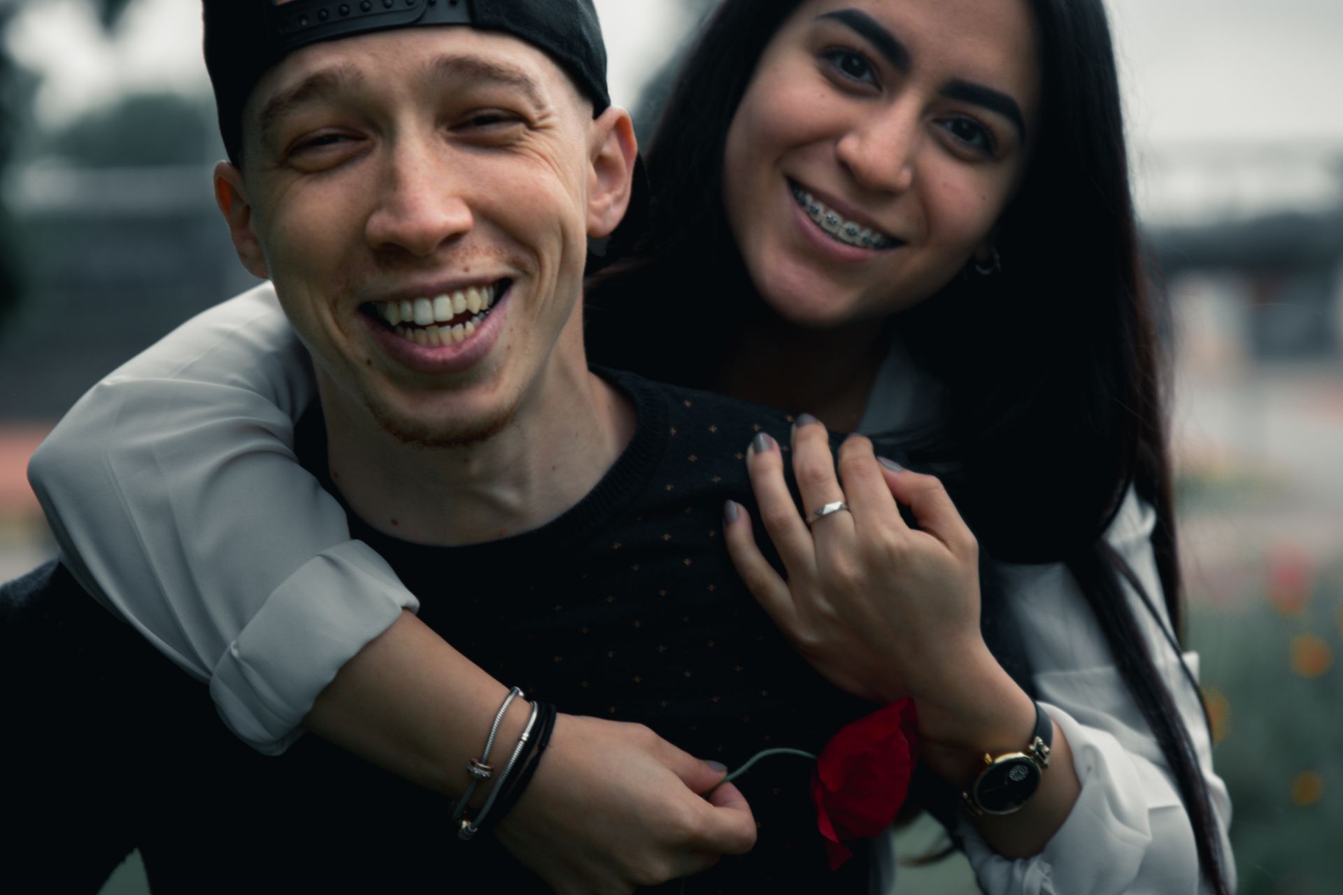 man in black long sleeve shirt smiling beside woman in white long sleeve shirt