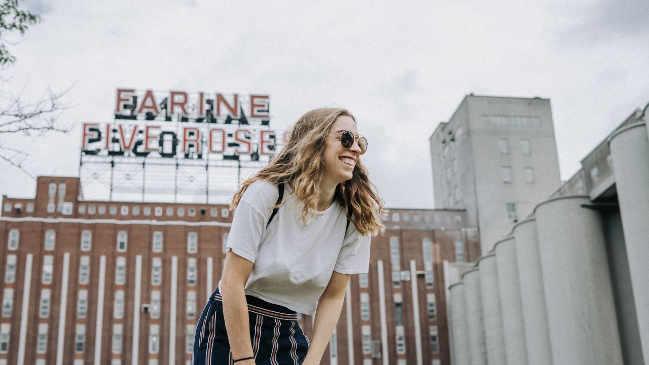 smiling woman standing near the building