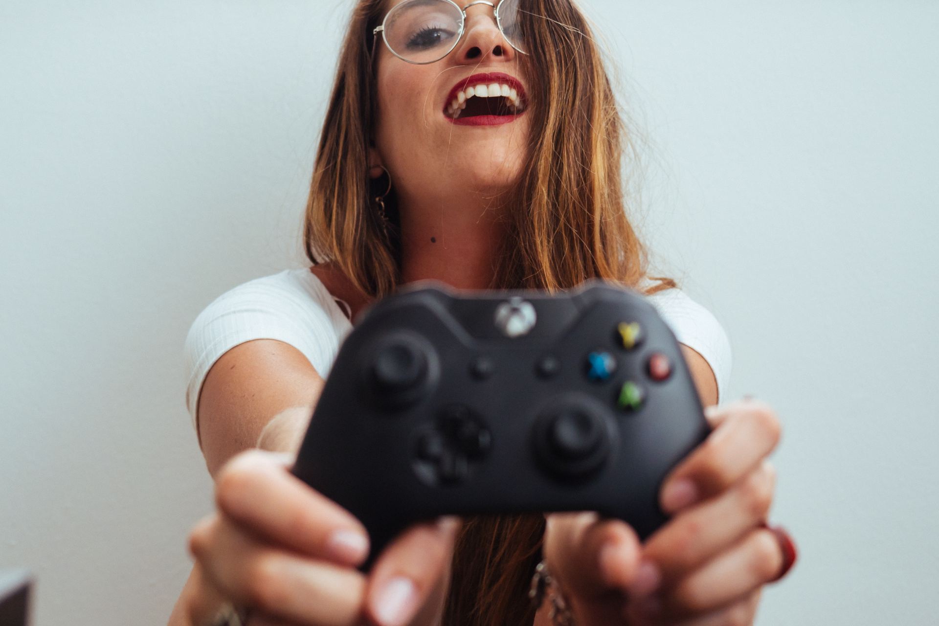 woman holding Xbox One controller
