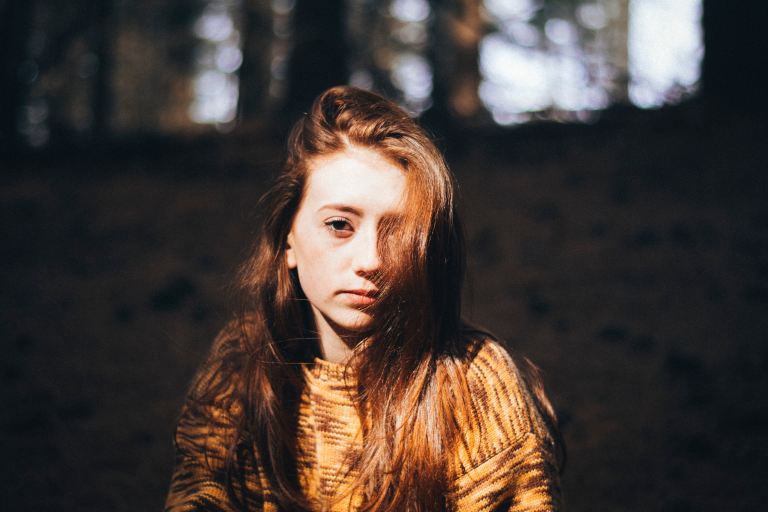 woman wearing brown crew-neck long-sleeved shirt