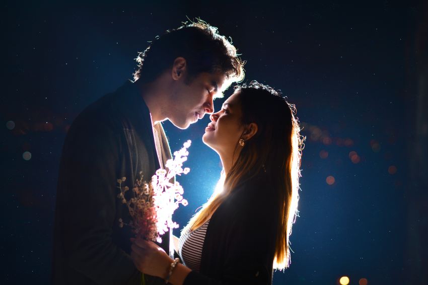 man and woman kissing during night time