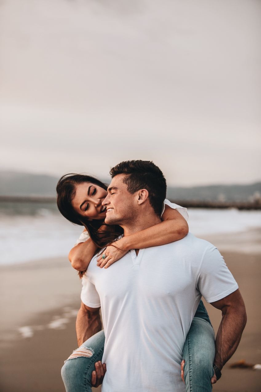 man in white crew neck t-shirt hugging woman in white t-shirt