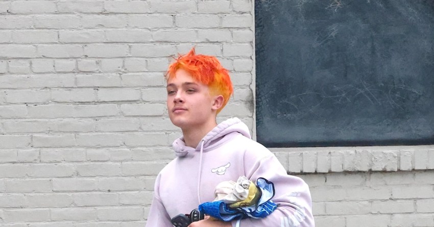 Knox Jolie-Pitt with bright orange hair exiting a gym