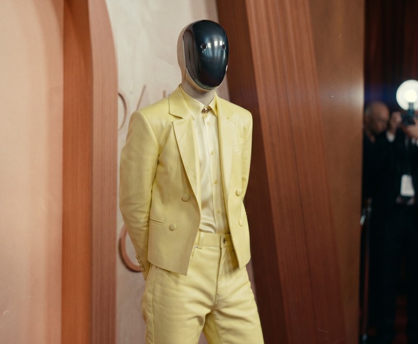A humanoid robot wearing a tailored uniform