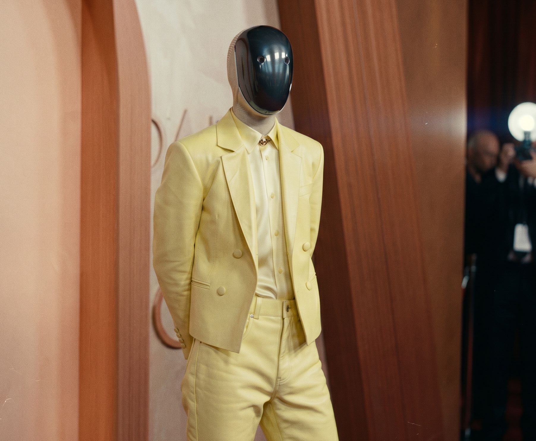 Click to open the image gallery Humanoid robot wearing a tailored uniform