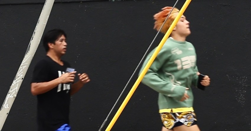 Knox Jolie-Pitt sprinting through the streets of Los Angeles during an outdoor workout session with a trainer