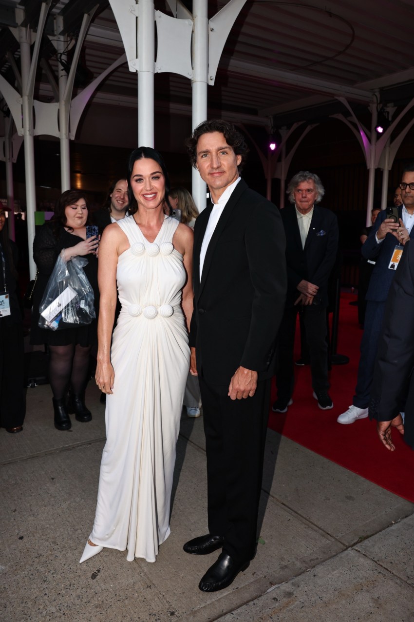 Katy Perry in a white gown and Justin Trudeau in a black suit posing on the red carpet at the Tribeca Festival in New York City