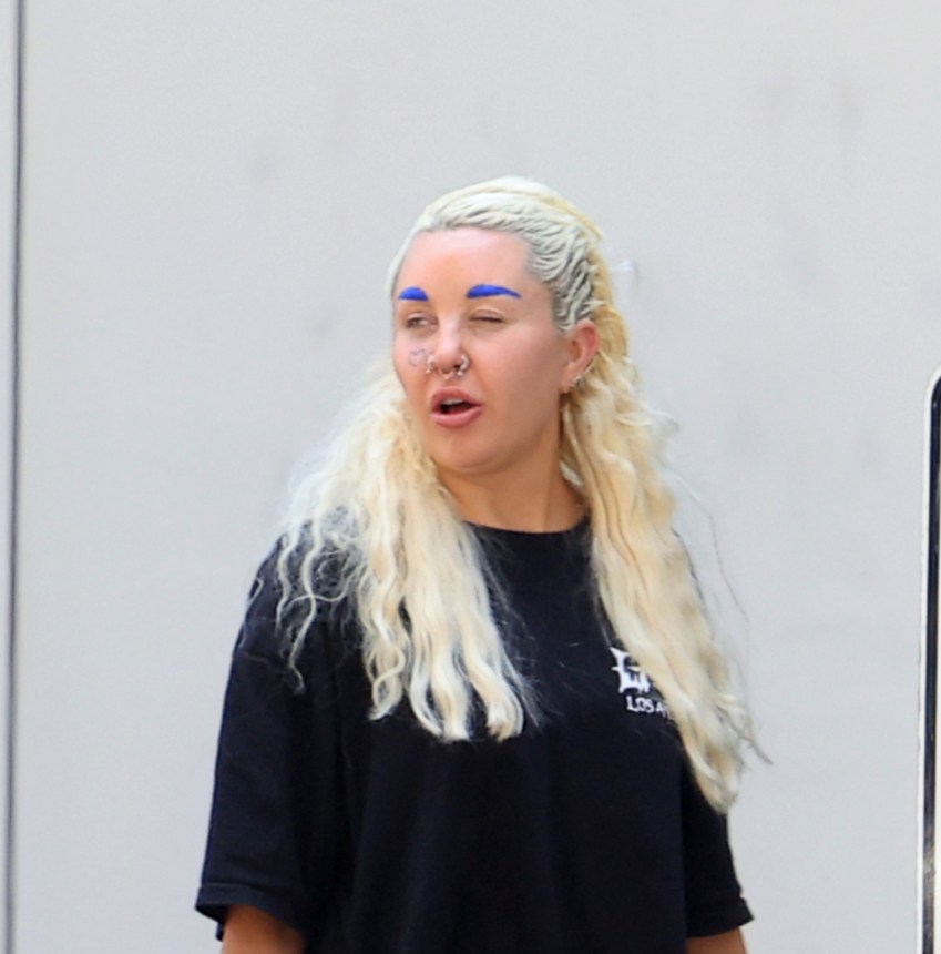 Amanda Bynes with blue eyebrows and a gold bottom grill out in Los Angeles with her boyfriend Zachary