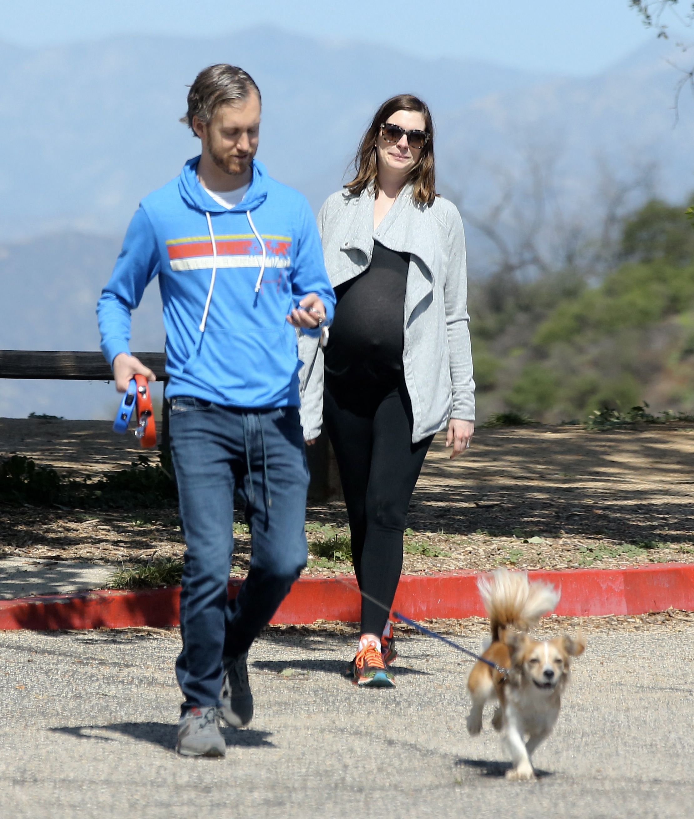 Click to open the image gallery A visibly pregnant Anne Hathaway hiking with husband Adam Shulman