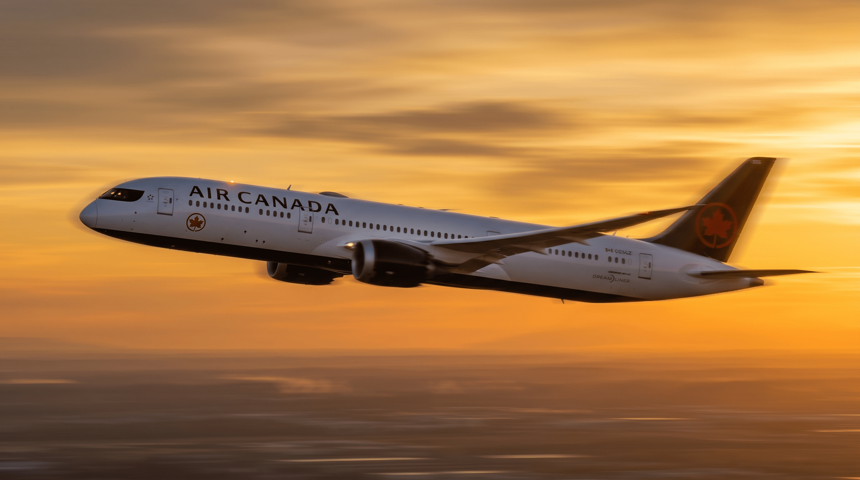 Air Canada Boeing 787 Dreamliner in flight against an orange and golden sunset sky