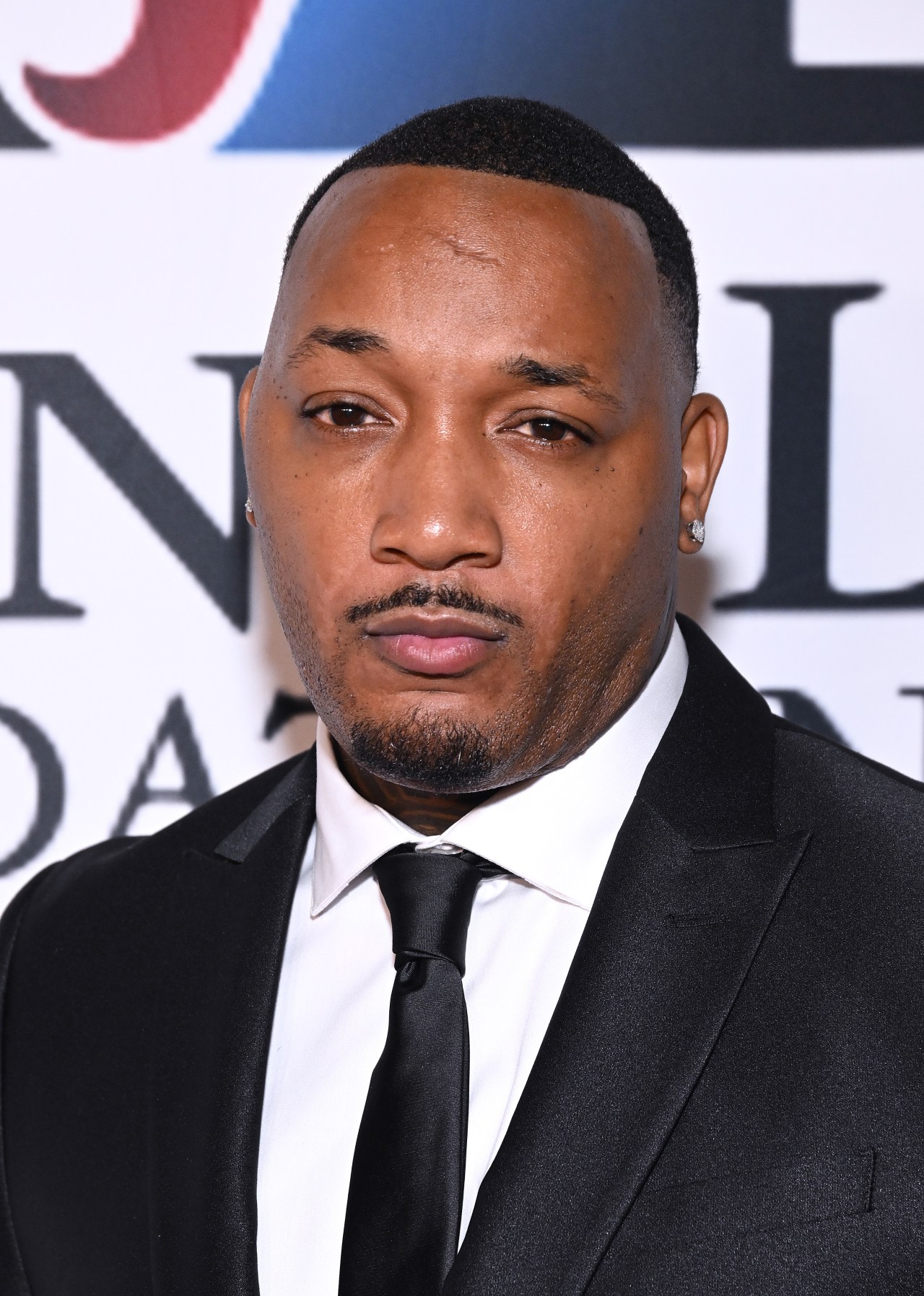 Jamal Morton wearing a black suit and tie at the 2024 Living Legends Foundation Awards dinner in Los Angeles.