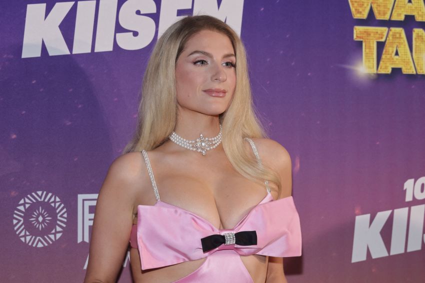 Alexandra Jarvis in a pink satin bow top and pearl choker necklace at the KIIS FM Wango Tango event backdrop.