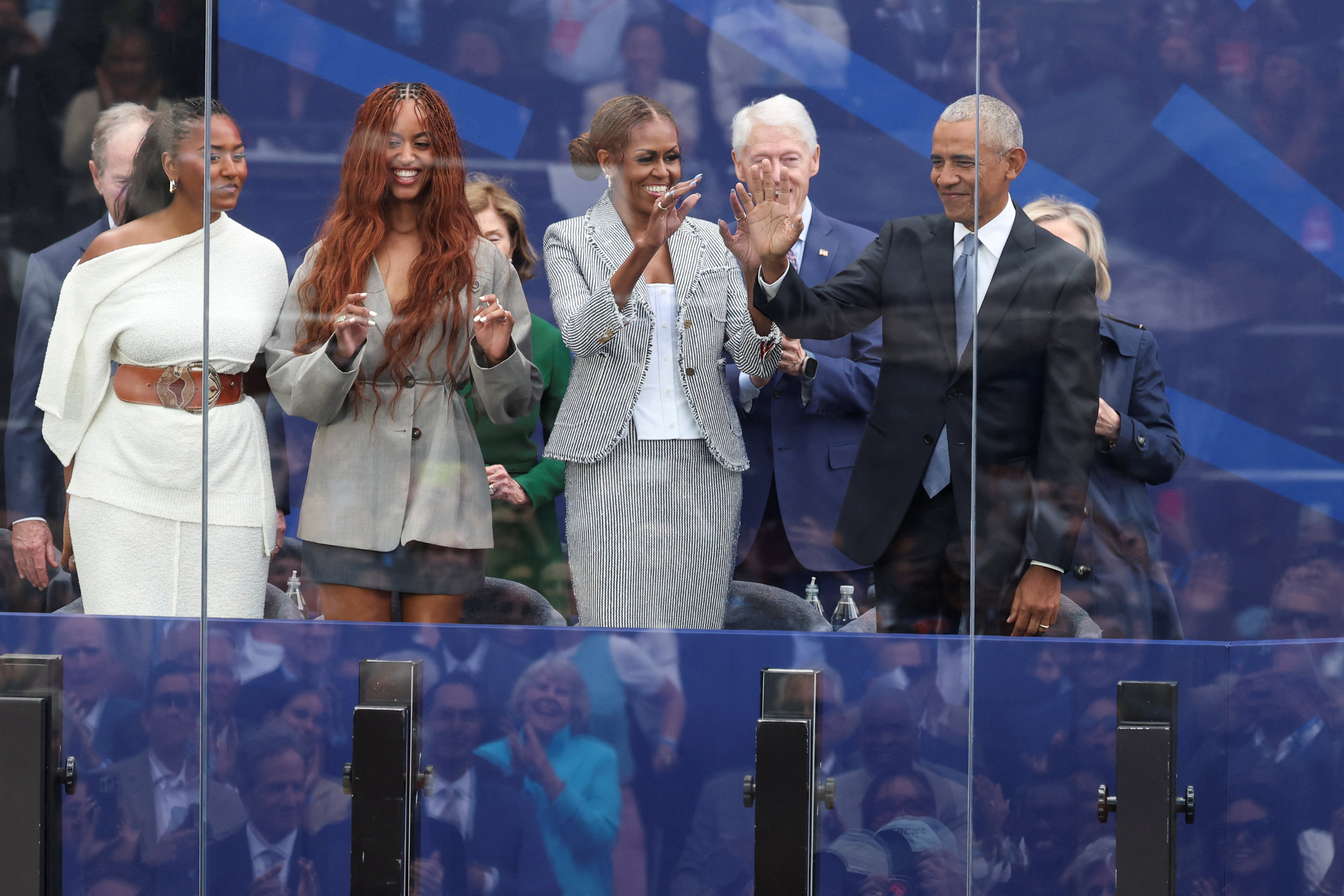 Barack Obama waving alongside Michelle, Malia, and Sasha Obama at the Obama Presidential Center dedication ceremony in Chicago
