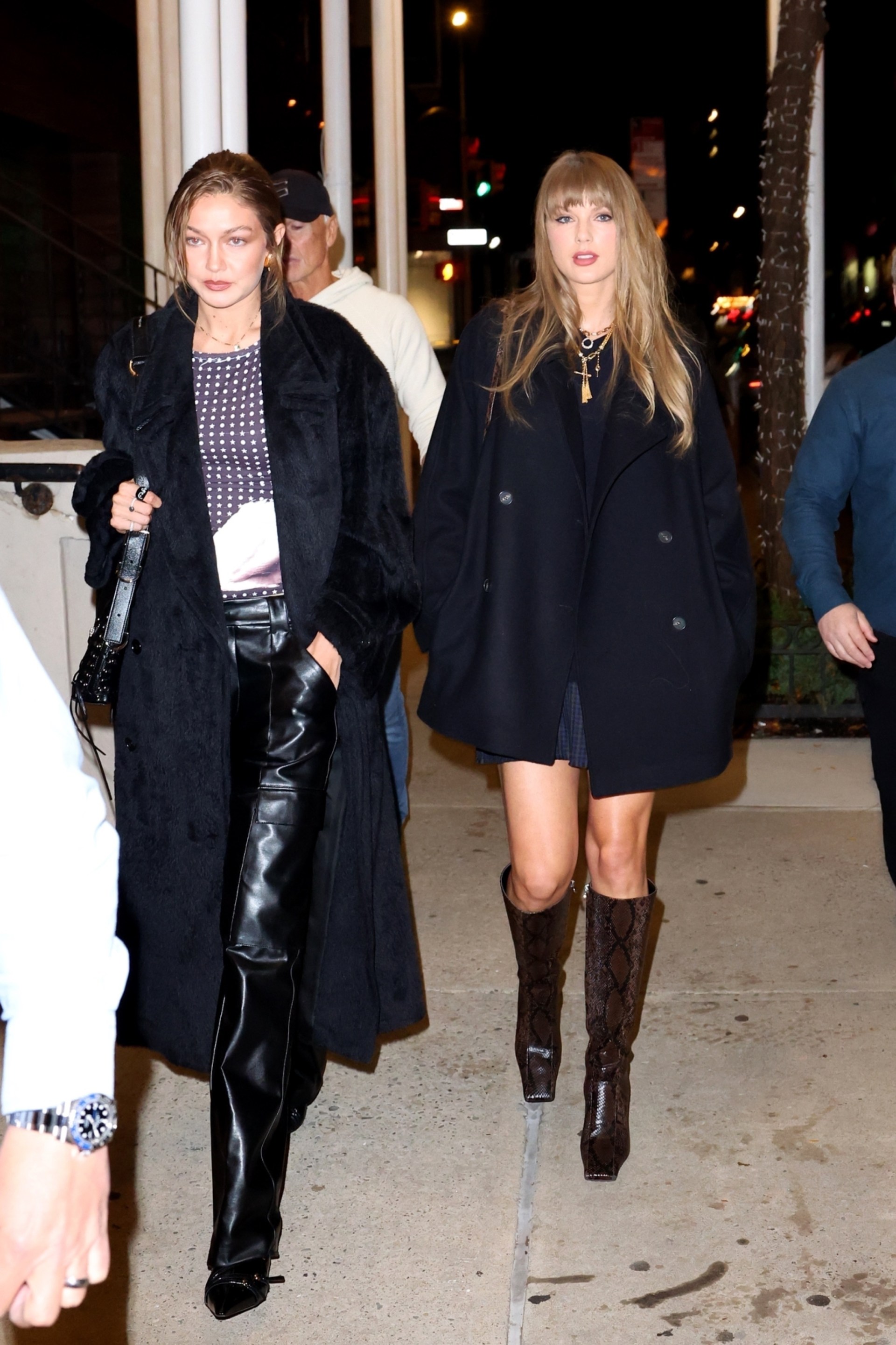 Taylor Swift and Gigi Hadid walking together in New York City, both dressed in coordinated black outfits