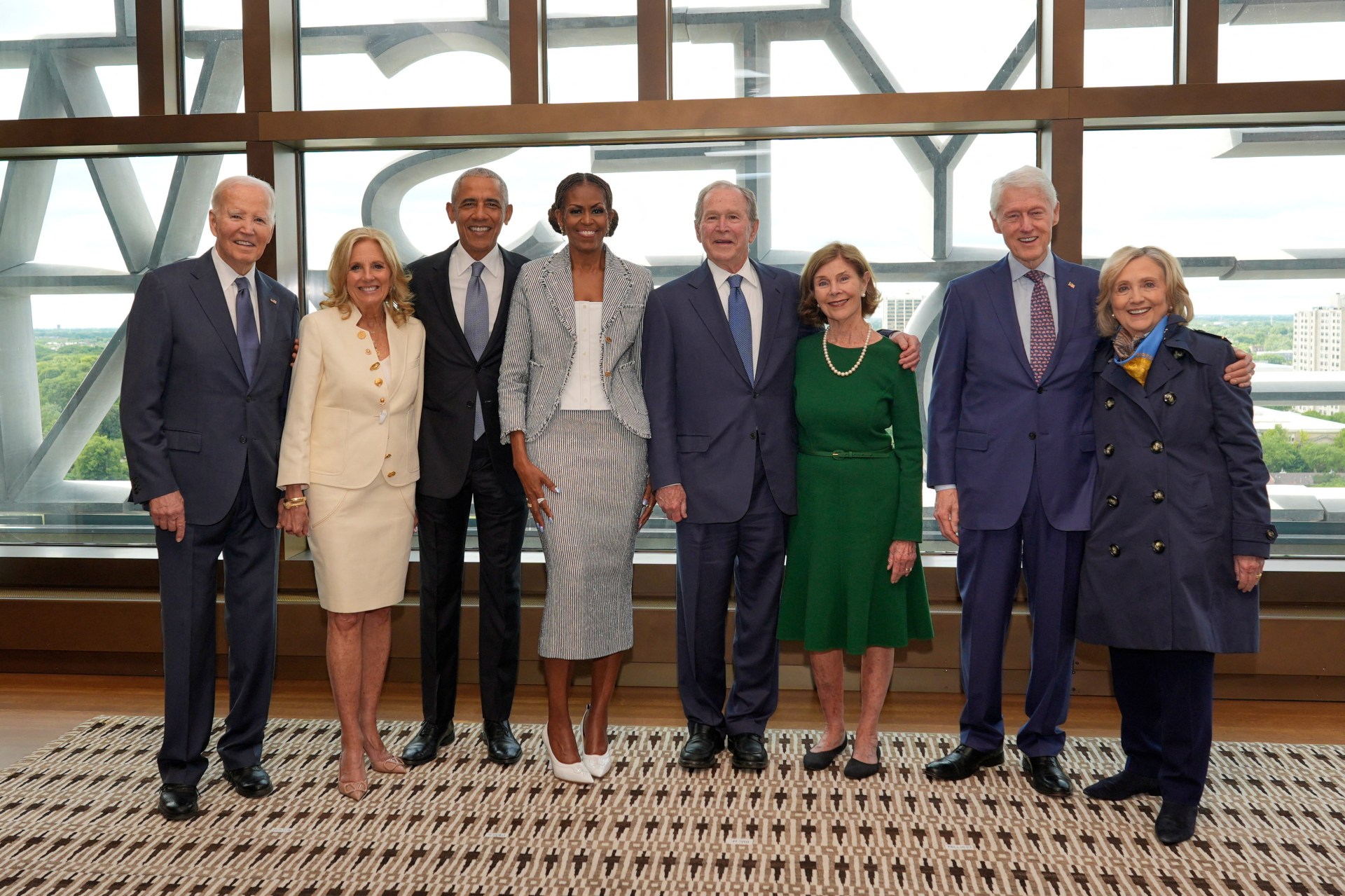 Four former U.S. presidents and their spouses posing together at the Obama Presidential Center dedication ceremony in Chicago