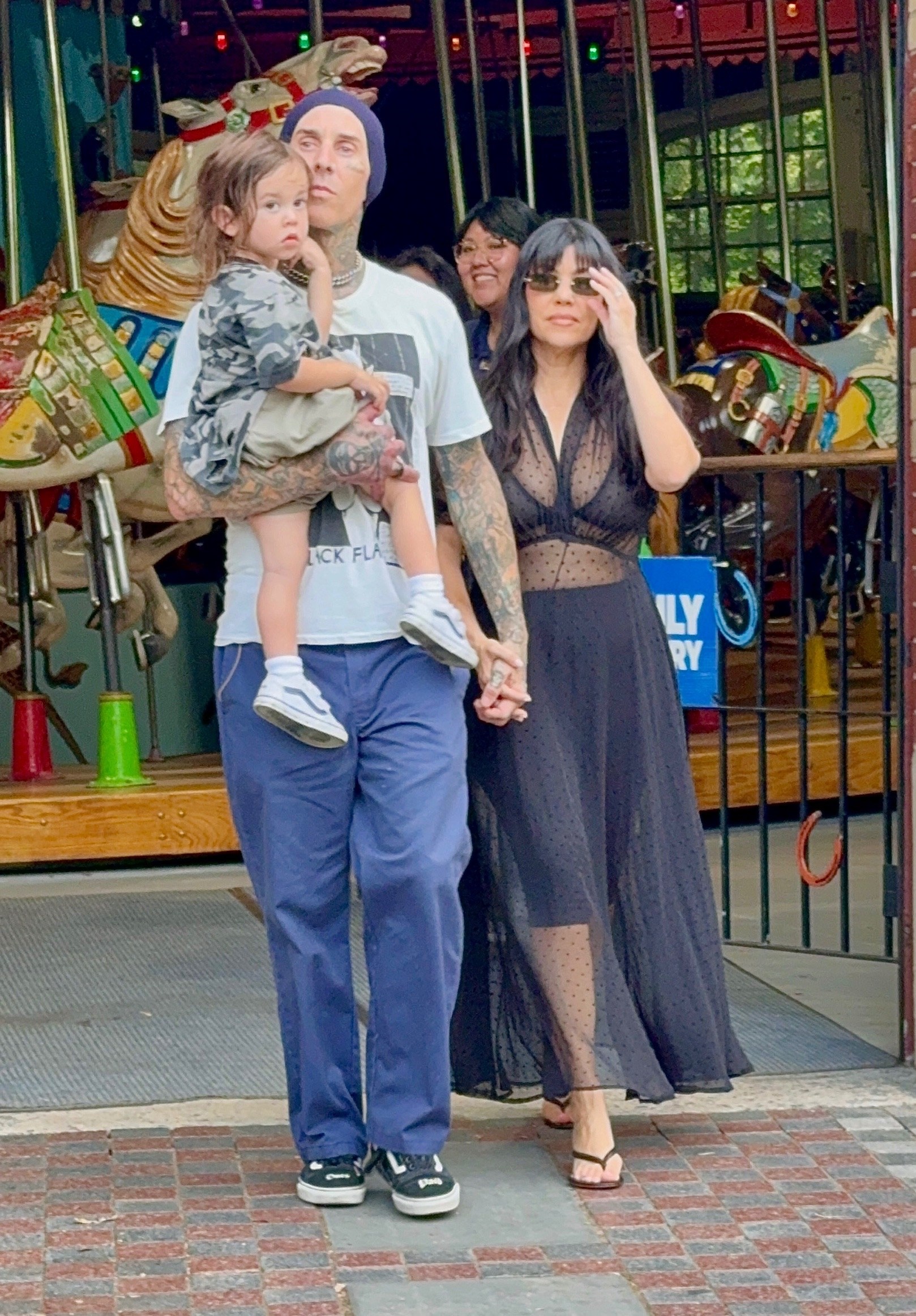 Travis Barker and Kourtney Kardashian walking with their young son Rocky near Central Park Carousel in New York City