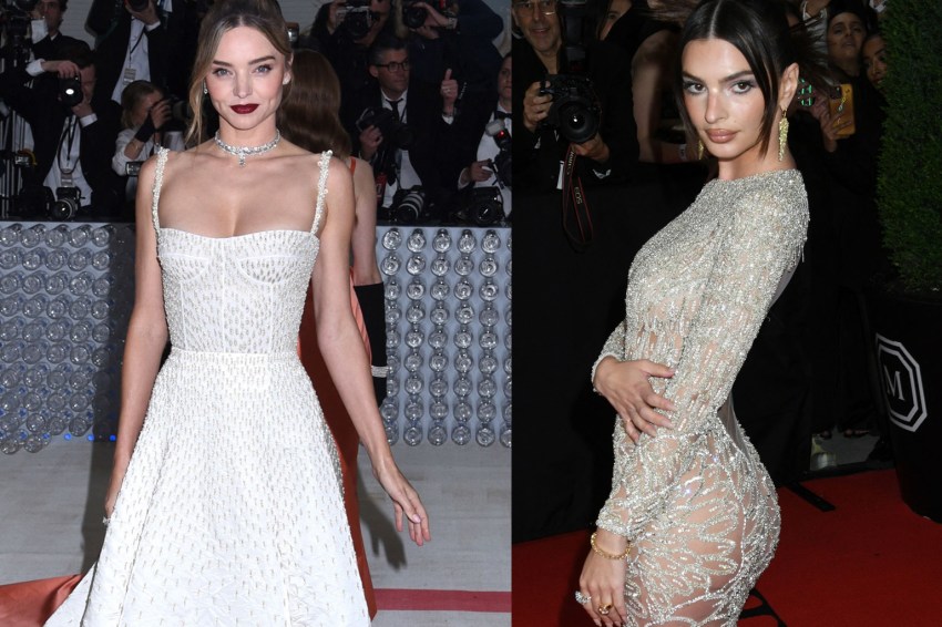 Miranda Kerr in a white tulle strapless gown holding a crystal clutch, standing beside a man in a black tuxedo on a red carpet.