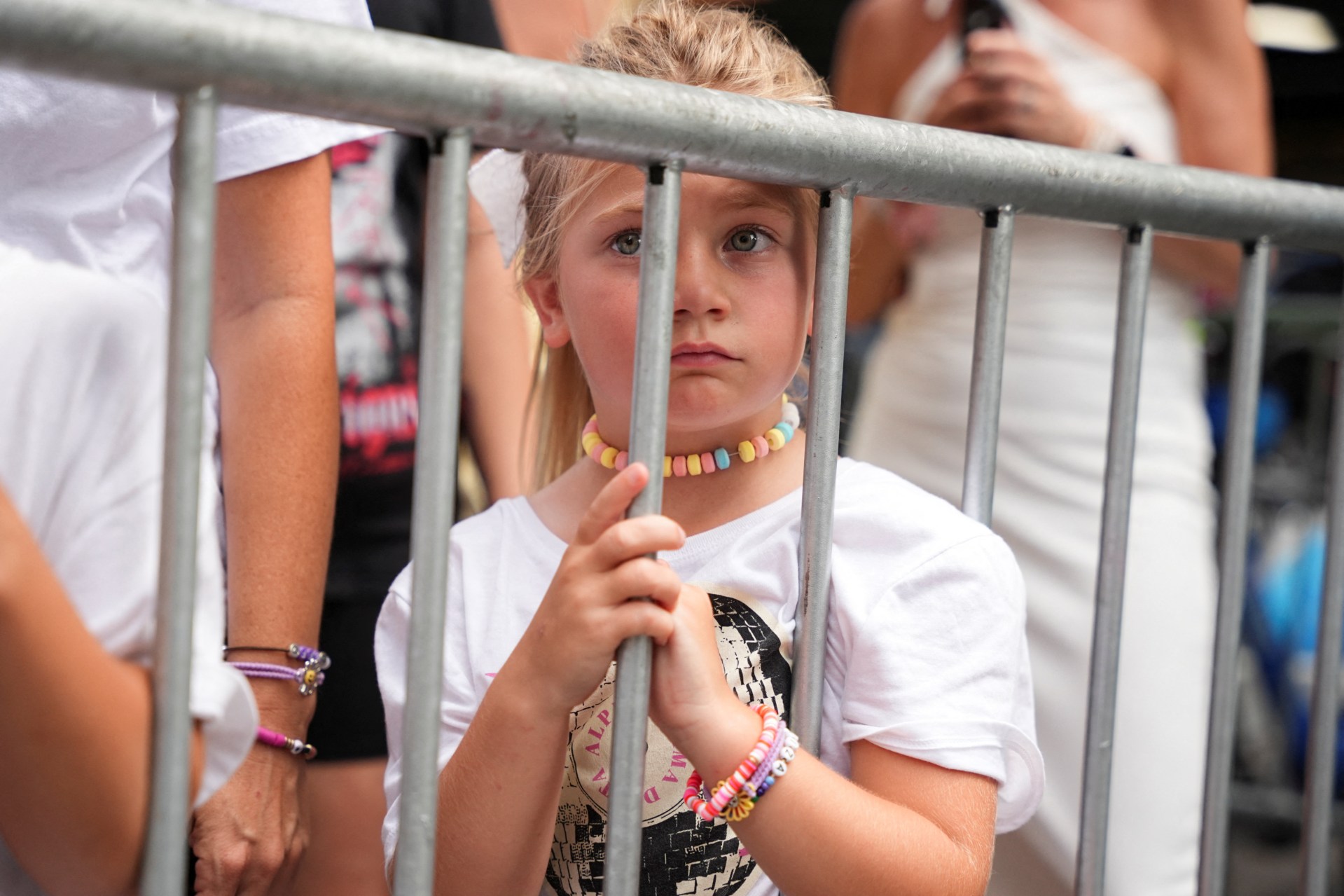 A child wearing a friendship bracelet standing outside Madison Square Garden in New York City