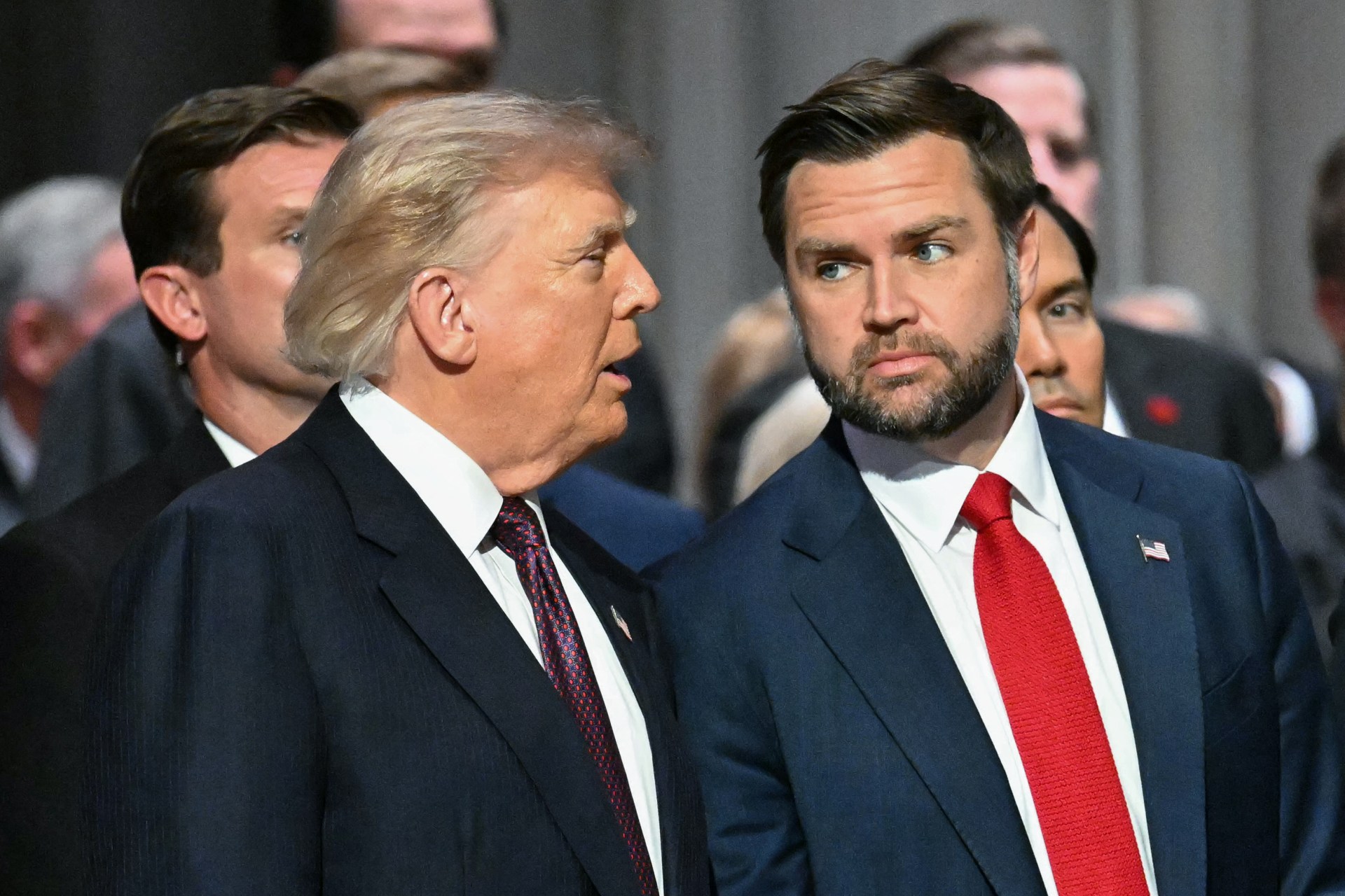 President Donald Trump and Vice President JD Vance in dark suits at a funeral service inside Washington National Cathedral.