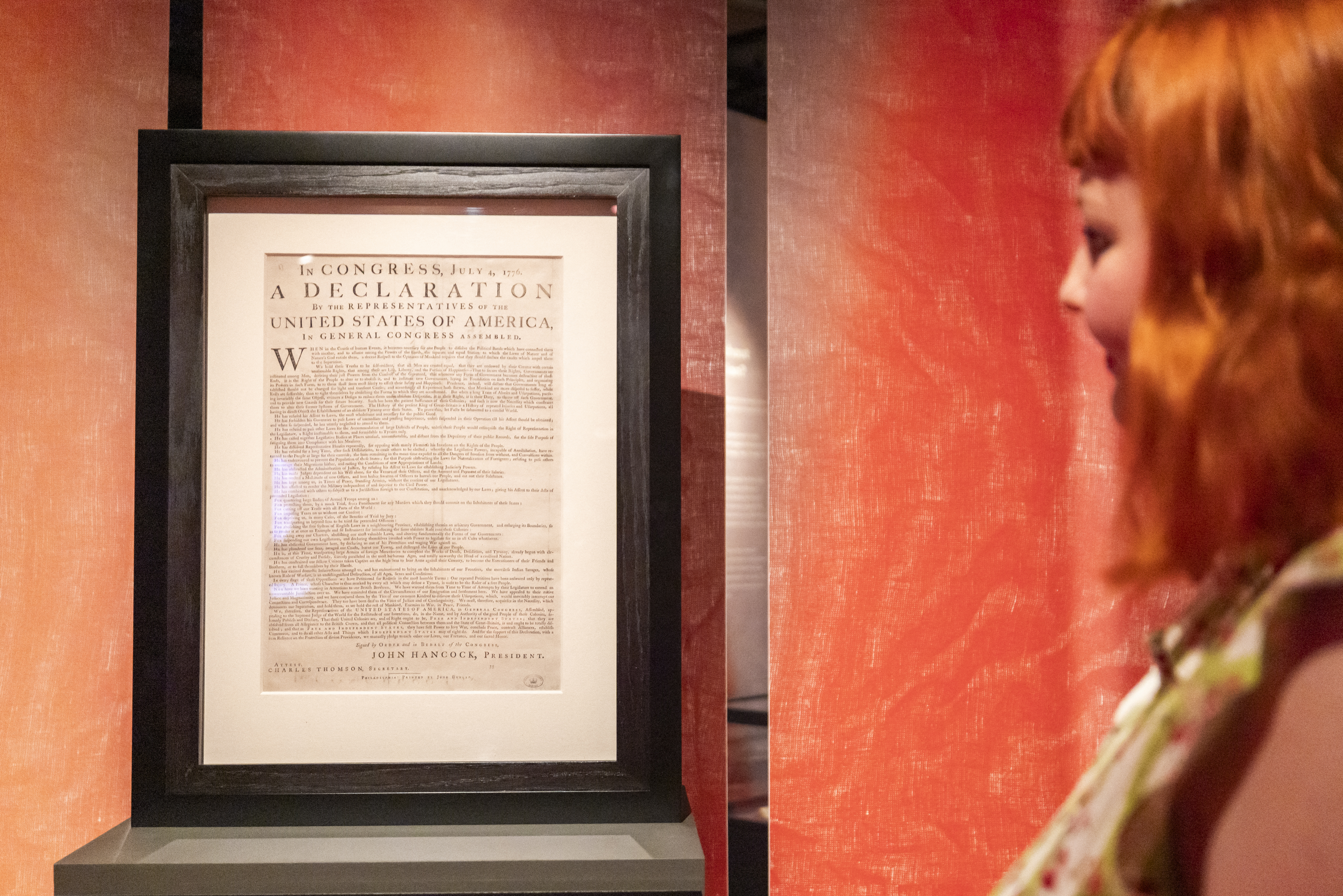A staff member views an original Dunlap broadside printing of the U.S. Declaration of Independence at The National Archives in Kew, London.