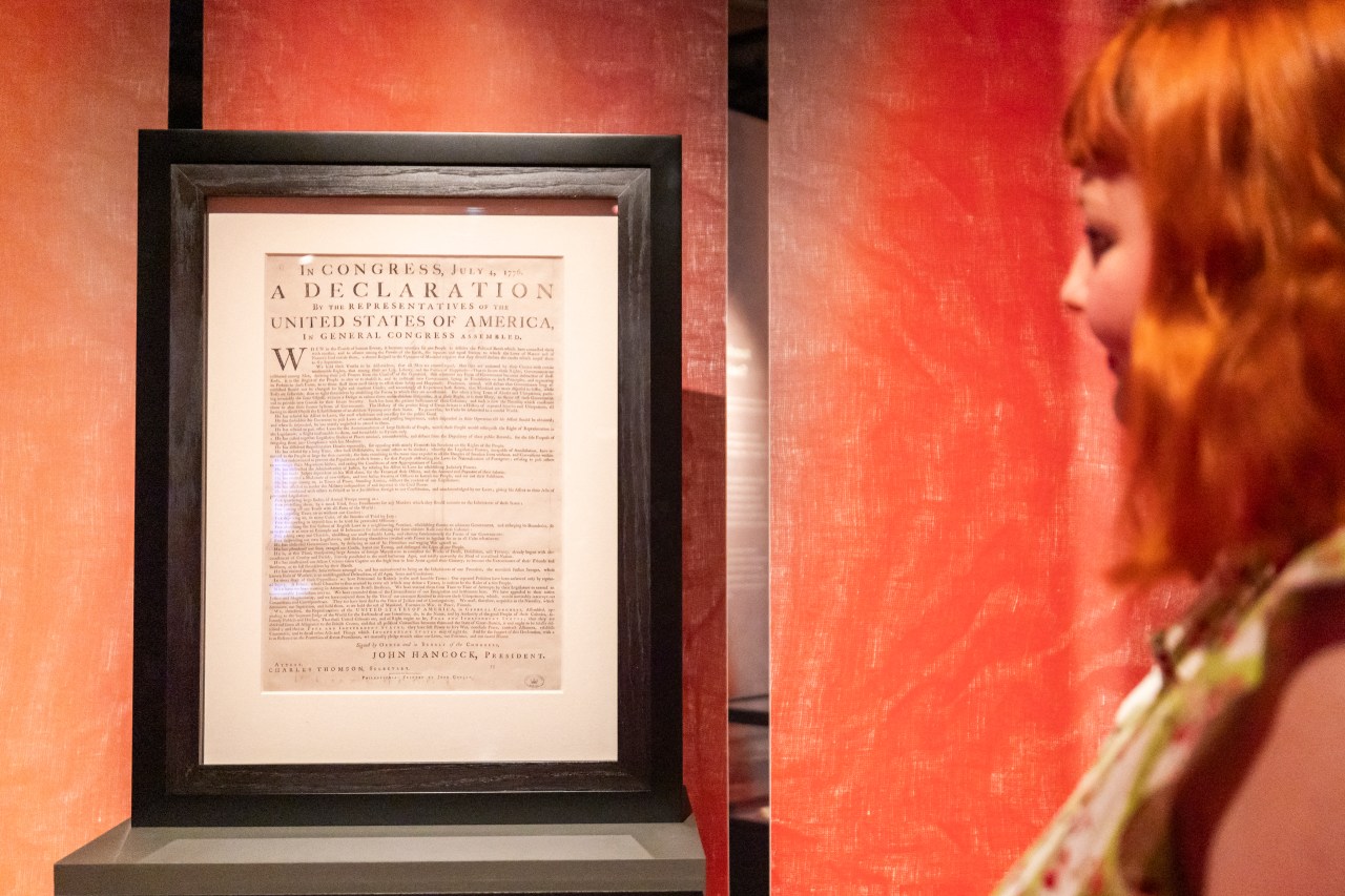 A staff member looks at an original printed copy of the U.S. Declaration of Independence on display at The National Archives in Kew, London.