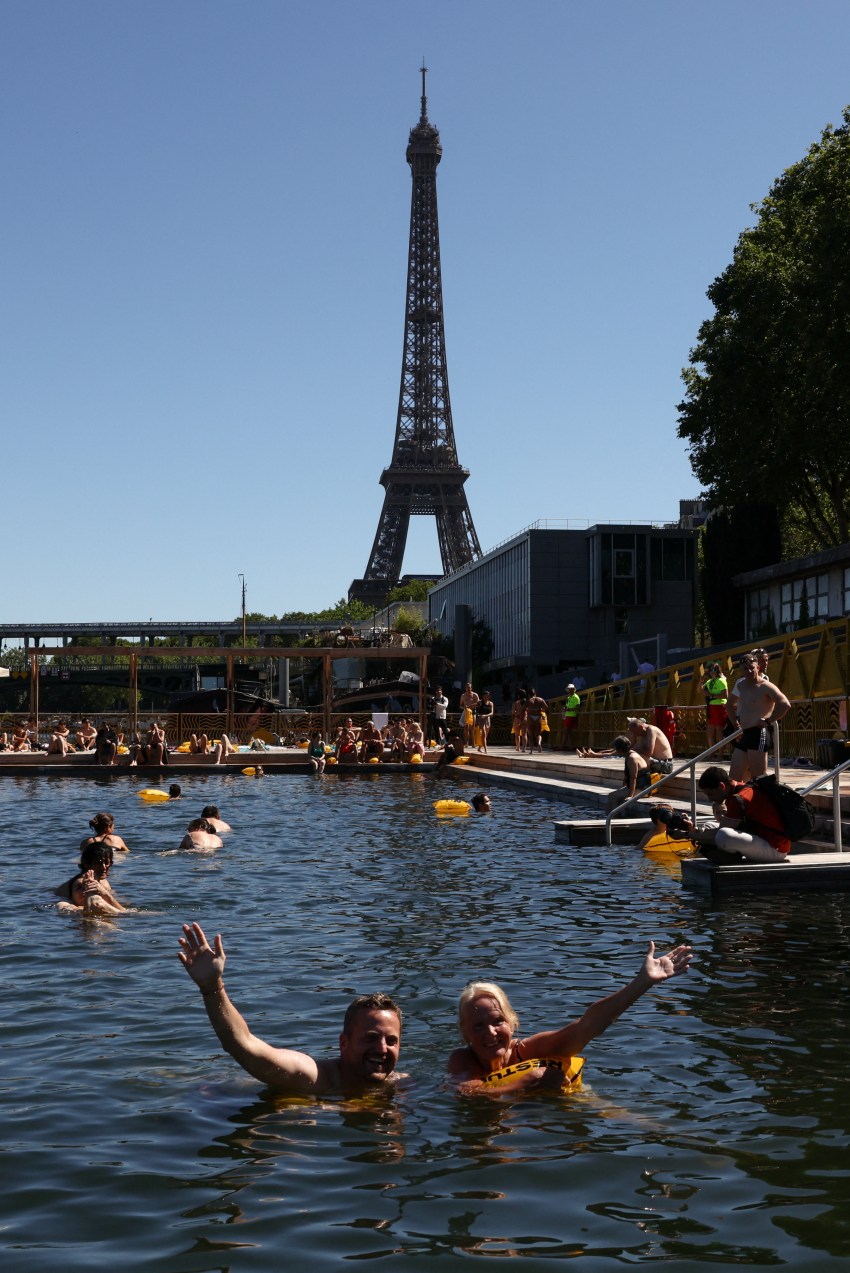 Swimmers in the River Seine at the Grenelle public bathing site in Paris with the Eiffel Tower in the background