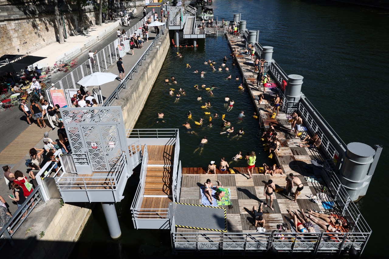 Swimmers in the Seine river at the Bras Marie bathing site in Paris