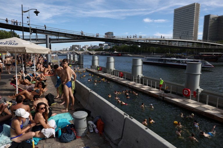 People swimming in the River Seine at the Bercy public swimming site in Paris