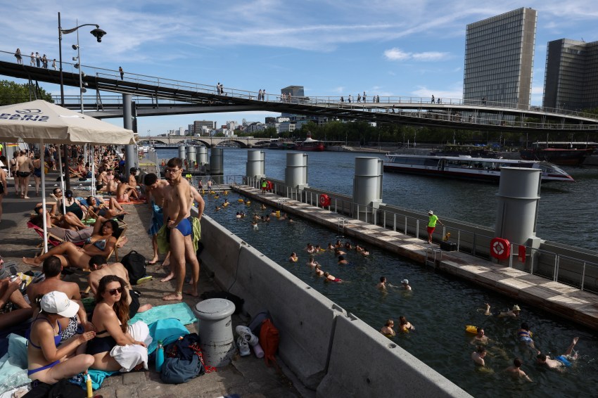 People swimming in the River Seine at the Bercy public swimming site in Paris