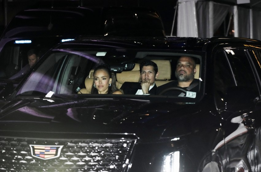 Jessica Alba and Danny Ramirez seated in the back of a black Cadillac SUV at night outside Madison Square Garden.