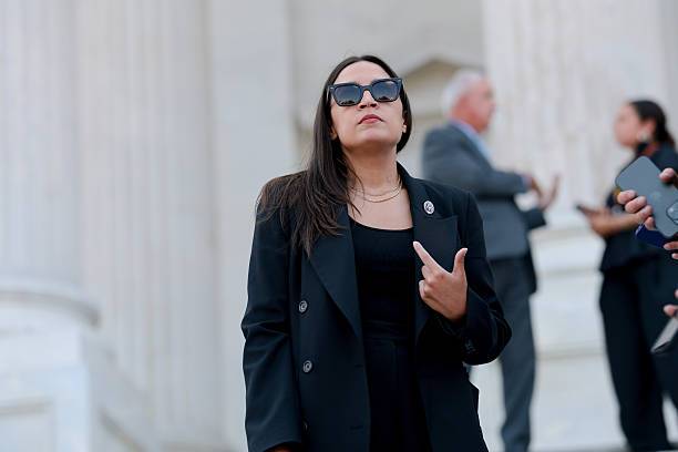 Alexandria Ocasio-Cortez speaking to reporters on the steps of the U.S. Capitol in Washington, DC