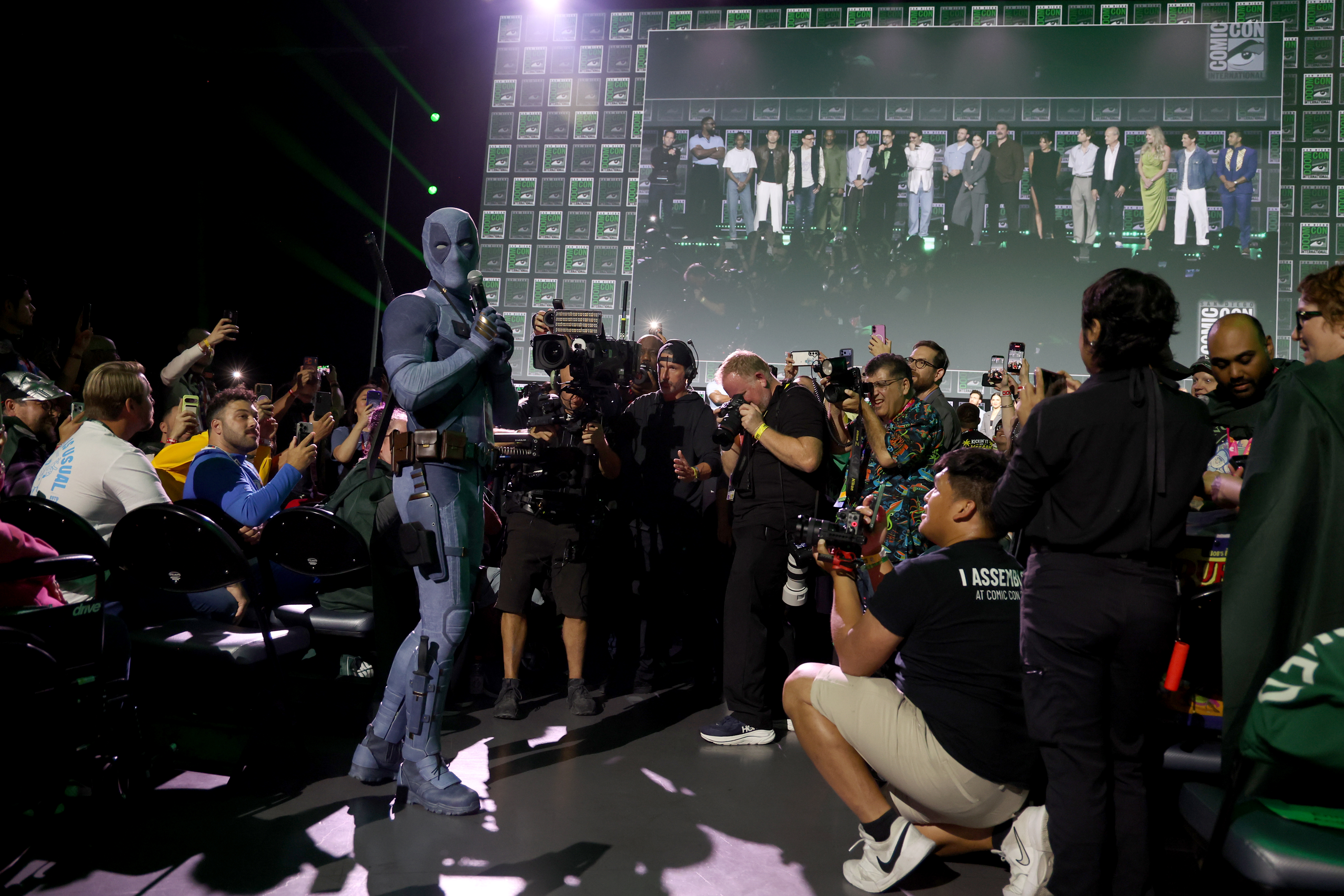 Ryan Reynolds dressed in a Deadpool costume speaking at the Marvel Studios panel at 2026 San Diego Comic-Con