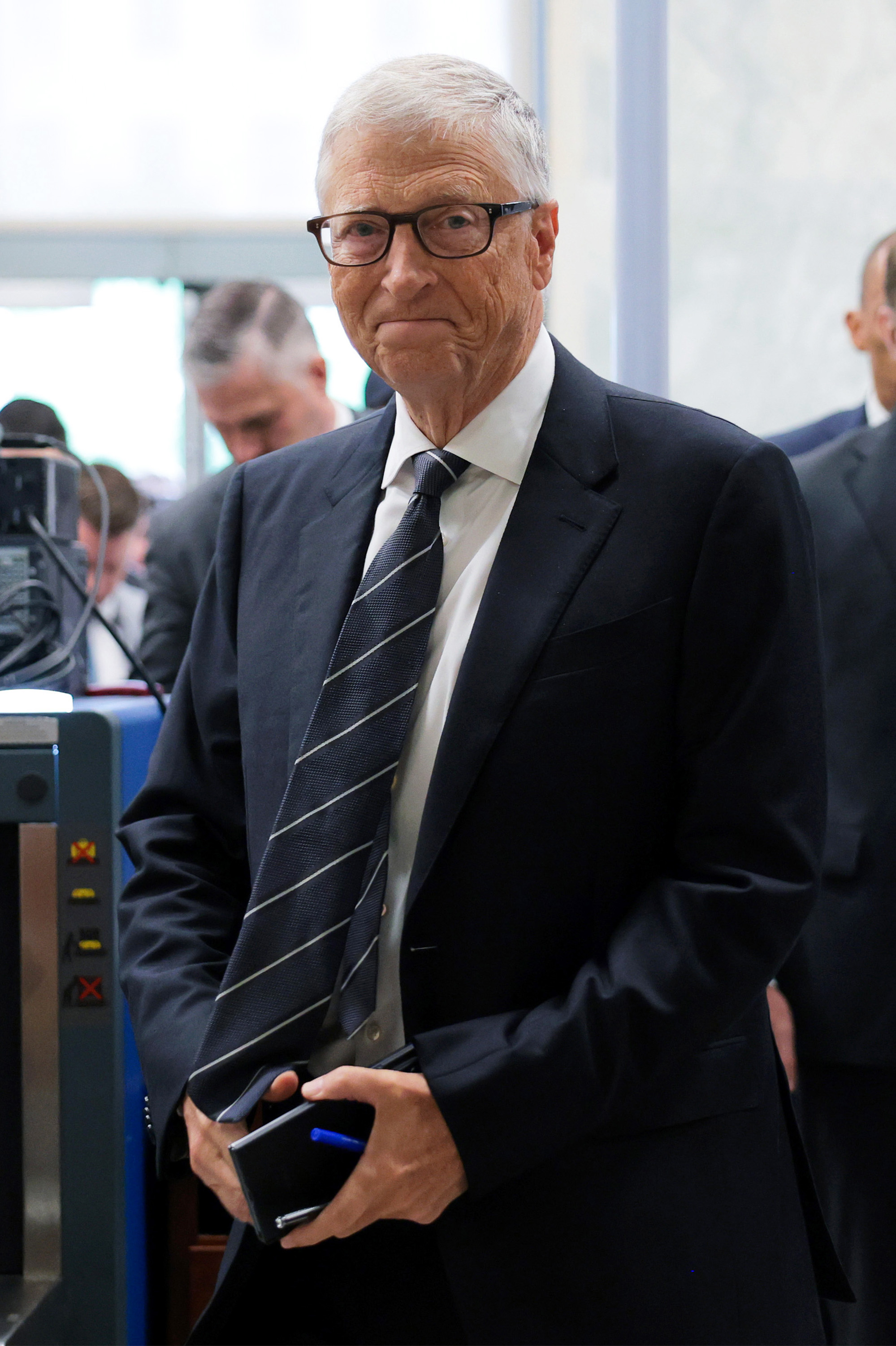 Bill Gates walking through a security checkpoint on Capitol Hill