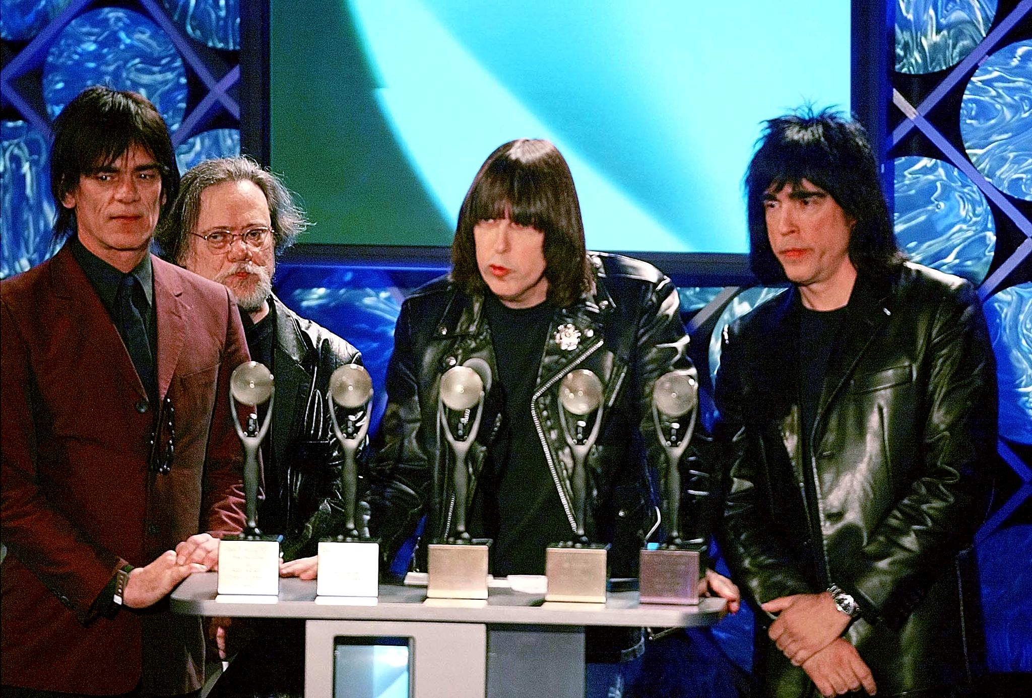 Dee Dee, Tommy, Johnny, and Marky Ramone holding their awards at the 2002 Rock and Roll Hall of Fame induction ceremony