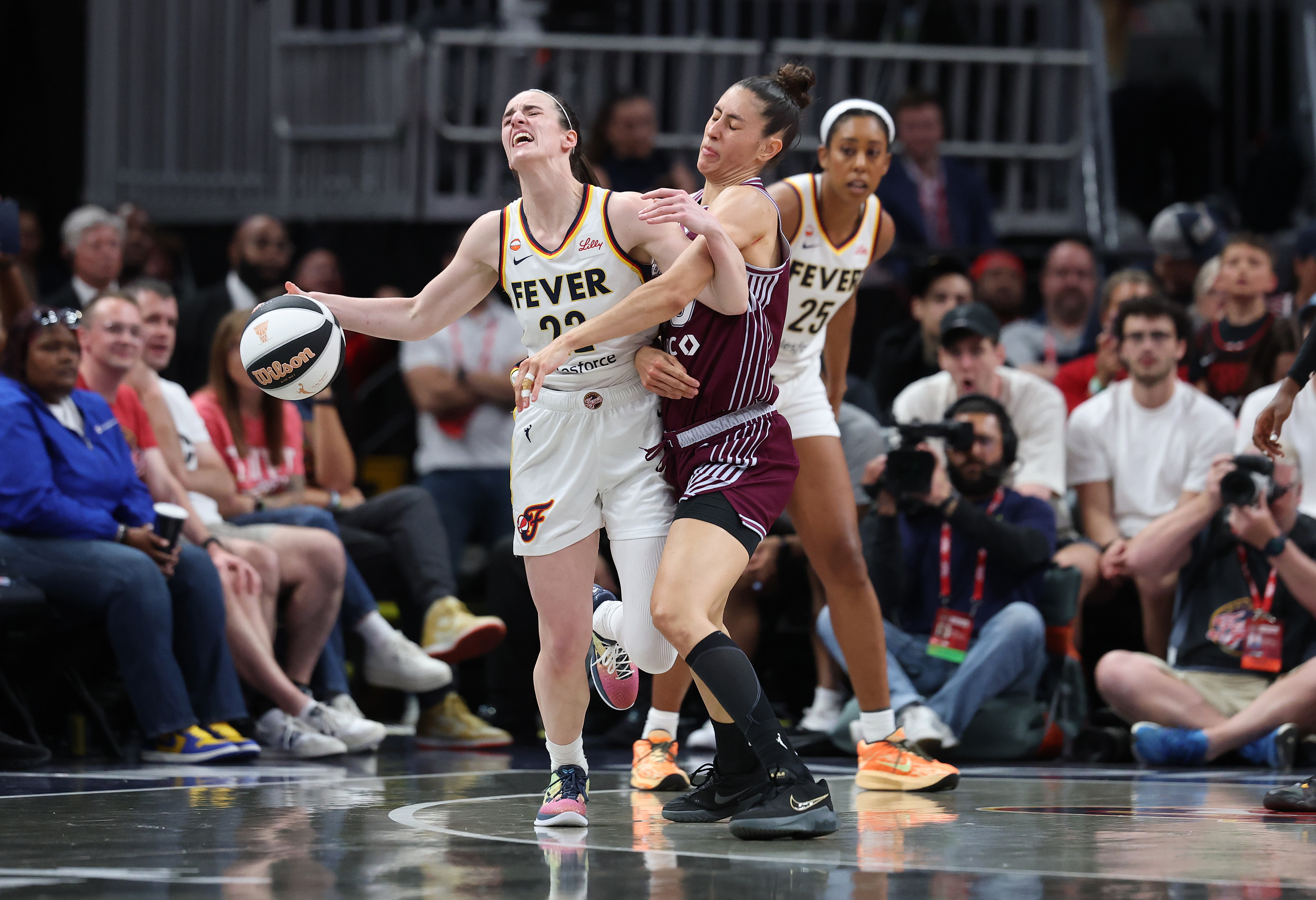Caitlin Clark of the Indiana Fever being fouled by Maria Conde of the Toronto Tempo during a WNBA game