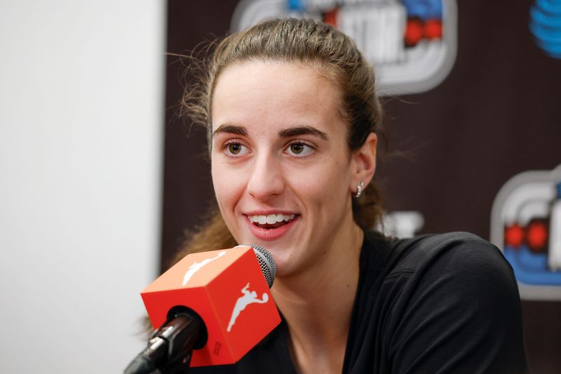 Caitlin Clark speaking at a podium during WNBA All-Star Weekend Media Day at the Obama Presidential Center in Chicago