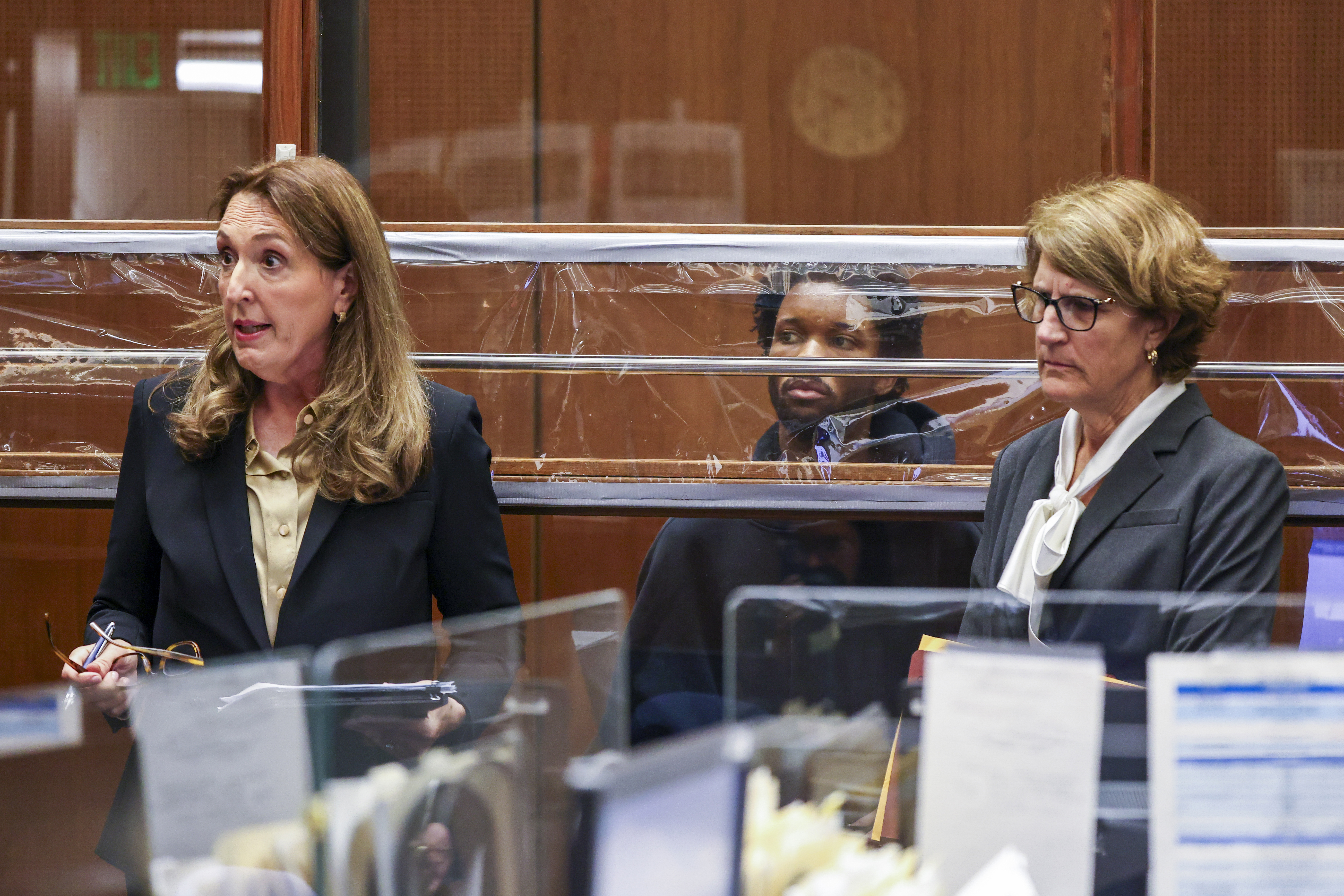 D4vd looking on in court as his defense attorneys Blair Berk and Marilyn Bednarski speak during his arraignment in Los Angeles