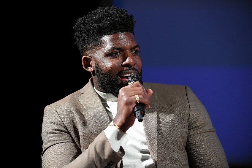 Emmanuel Acho speaking onstage at a screening event at Paramount Studios in Los Angeles
