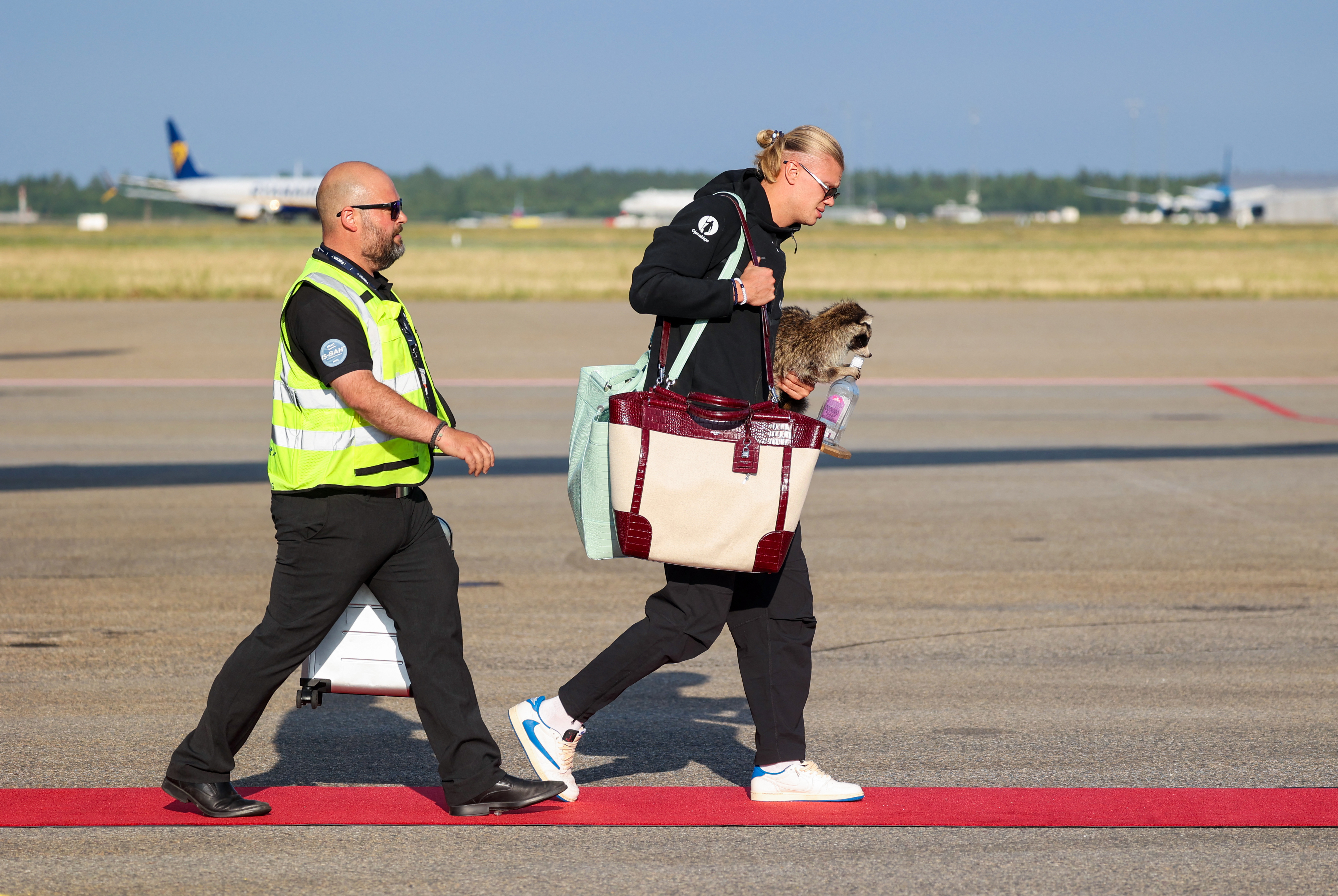 Erling Haaland on the tarmac at Oslo's Gardermoen Airport after arriving home from the 2026 World Cup