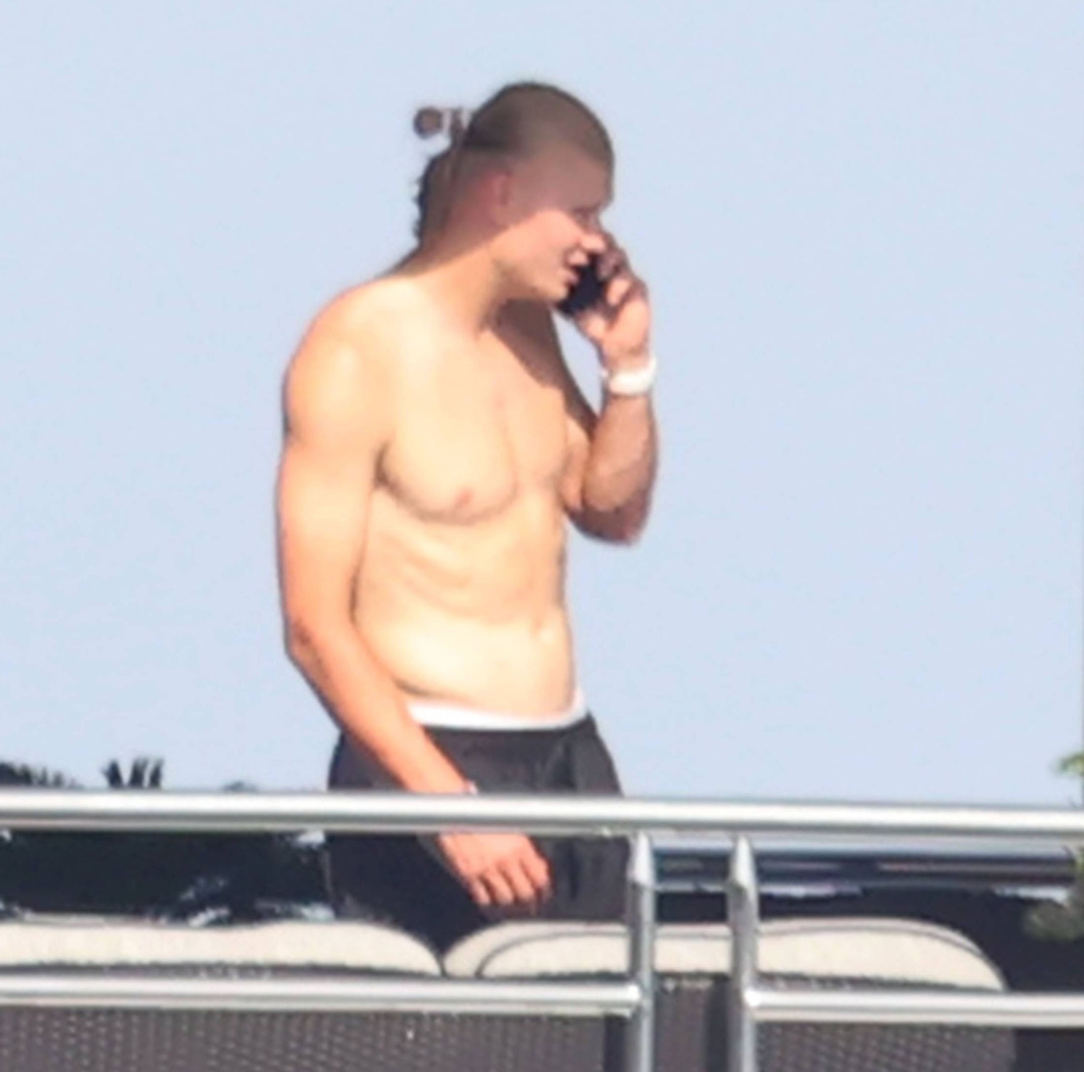 Erling Haaland shirtless on a yacht in Taormina, Sicily, holding his baby, with Sander Berge nearby