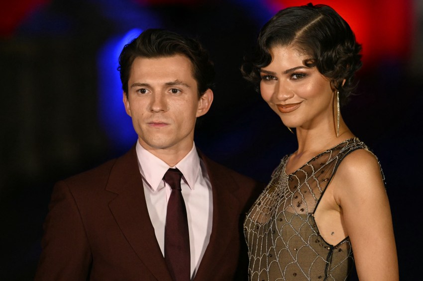 Zendaya and Tom Holland posing on a bridge in front of Castel Sant'Angelo in Rome at a Spider-Man: Brand New Day red carpet event.
