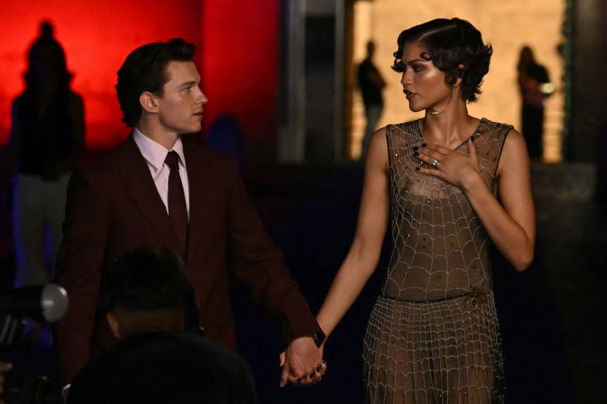 Zendaya and Tom Holland posing together on a bridge in front of Castel Sant'Angelo in Rome