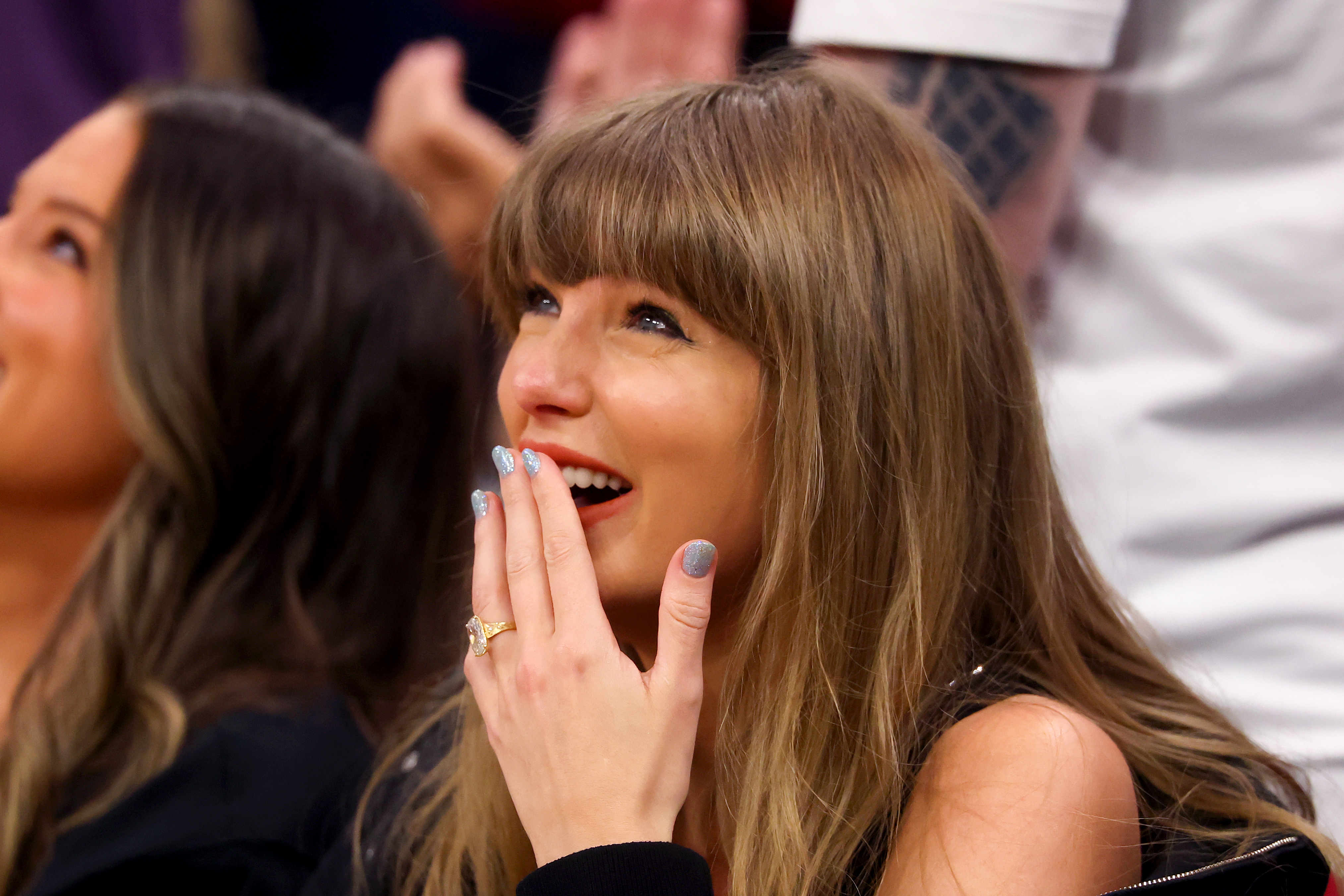 Taylor Swift sitting in the stands at Rocket Arena watching an NBA Eastern Conference Finals game