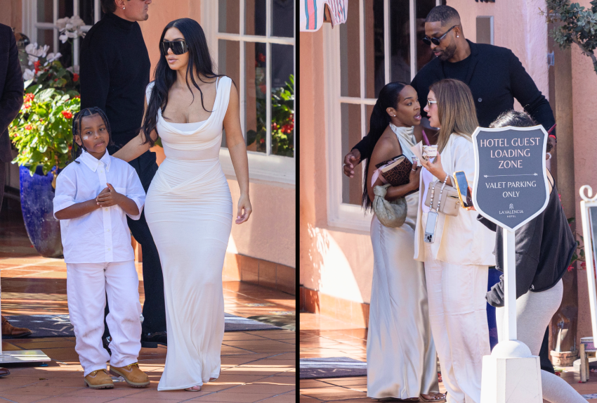Woman in white fitted dress and large sunglasses walking beside a young boy in a white shirt and pants on a hotel patio.