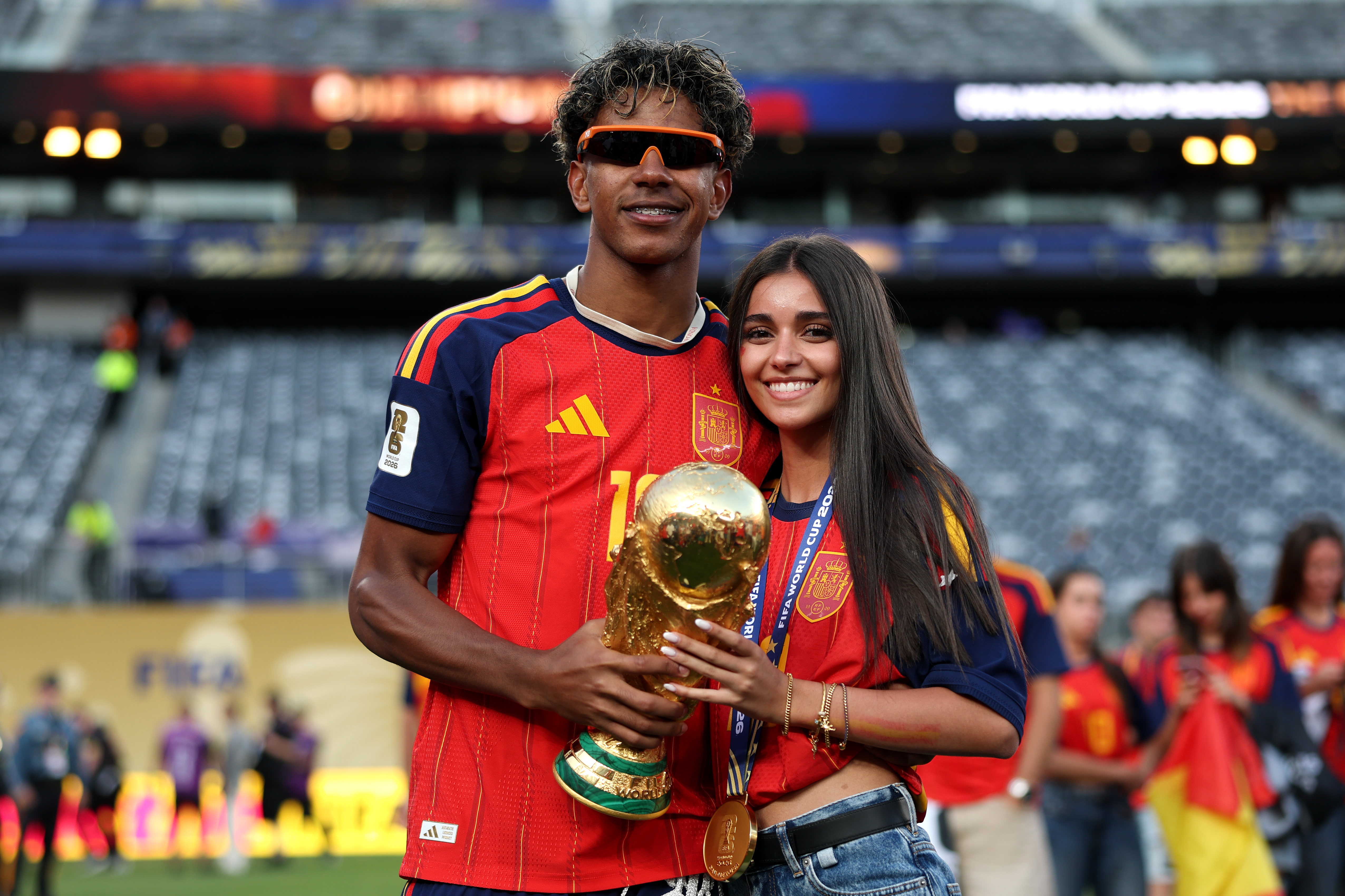Click to open the image gallery Lamine Yamal and girlfriend Inés García embrace on the pitch after Spain's FIFA World Cup 2026 Final victory over Argentina