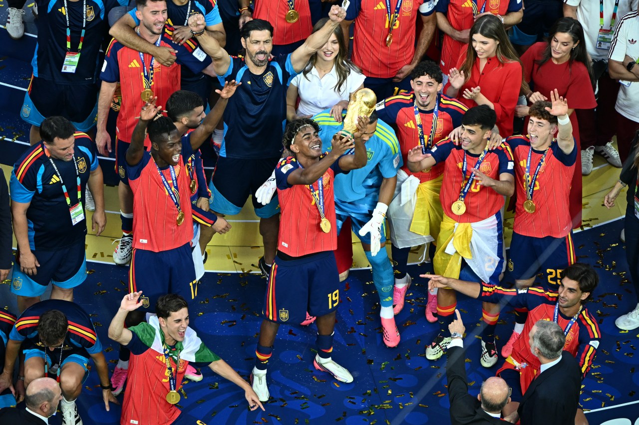 Lamine Yamal and Spain teammates lifting the FIFA World Cup trophy after beating Argentina in the 2026 final