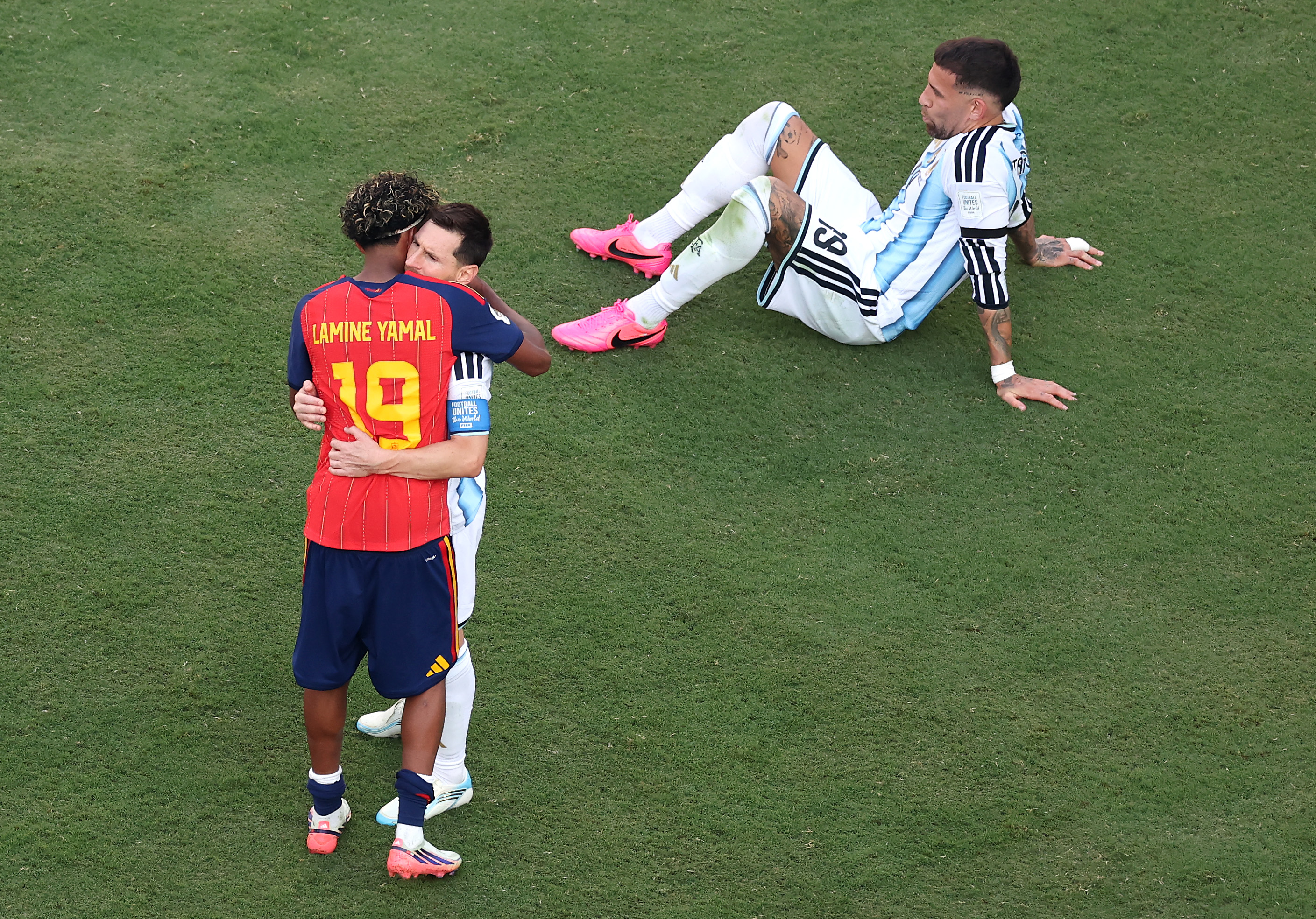 Lionel Messi and Lamine Yamal embracing on the field after the 2026 FIFA World Cup Final in East Rutherford, New Jersey